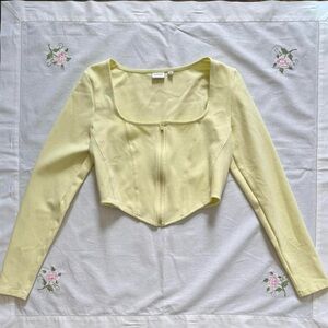 pale yellow Aritzia Sunday Best zip up long sleeve crop/corset-style top size M